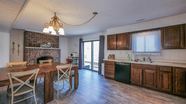 kitchen with dishwasher, decorative light fixtures, light wood-type flooring, and a wealth of natural light