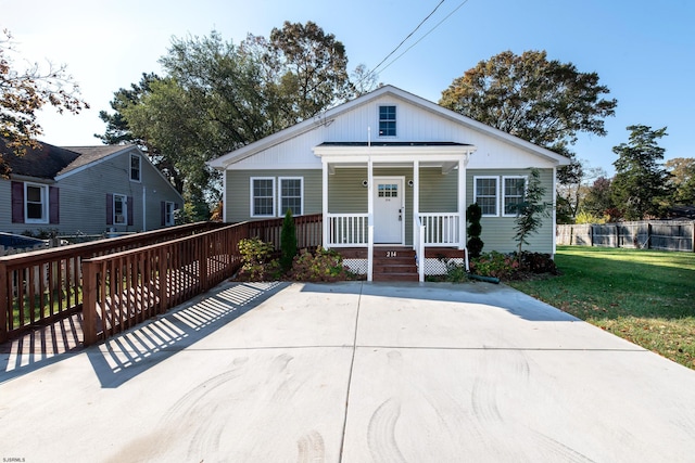 bungalow-style house featuring covered porch and a front lawn