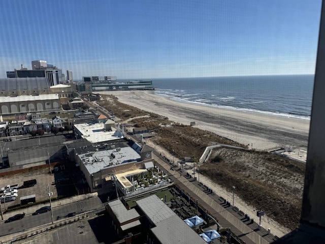 birds eye view of property with a beach view and a water view