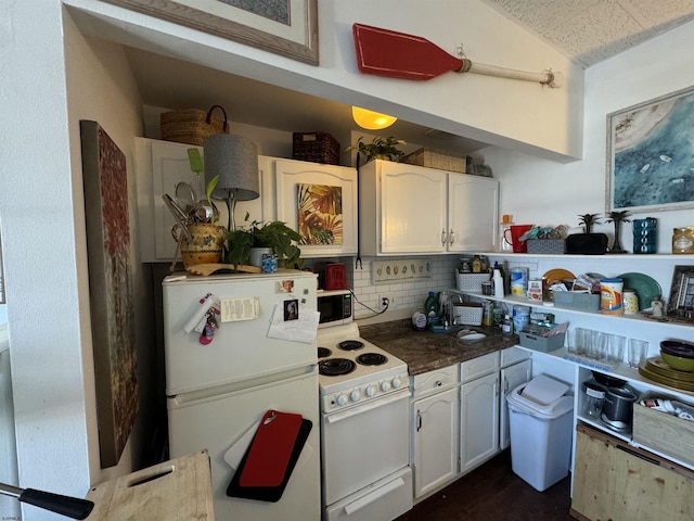 kitchen with backsplash, white cabinetry, and white appliances