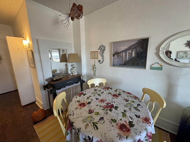 dining area with dark hardwood / wood-style flooring