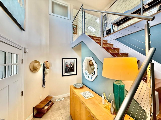 staircase featuring tile patterned flooring