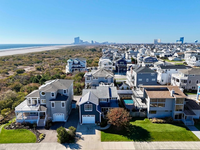 bird's eye view featuring a view of the beach and a water view