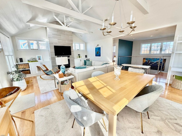 dining area featuring a fireplace, plenty of natural light, and light wood-type flooring