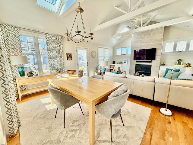 dining area with beam ceiling, hardwood / wood-style flooring, and plenty of natural light