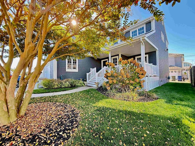 view of front of property with a front yard and a porch