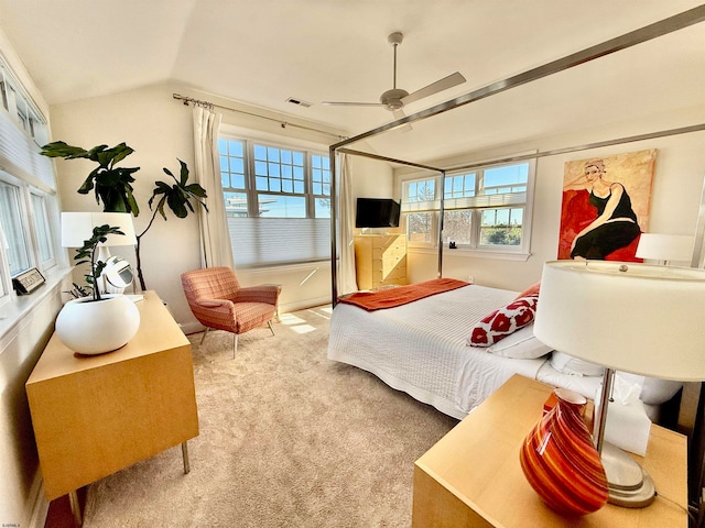 bedroom featuring carpet flooring, vaulted ceiling, and ceiling fan