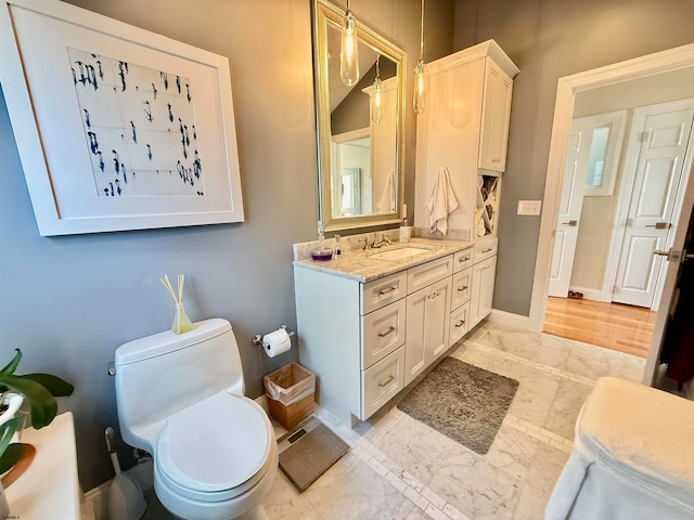 bathroom featuring vanity and toilet