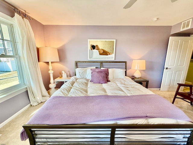 bedroom with ceiling fan and light colored carpet