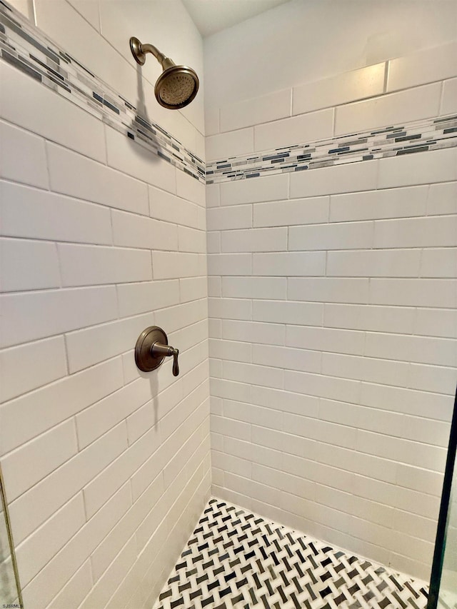 bathroom with tiled shower