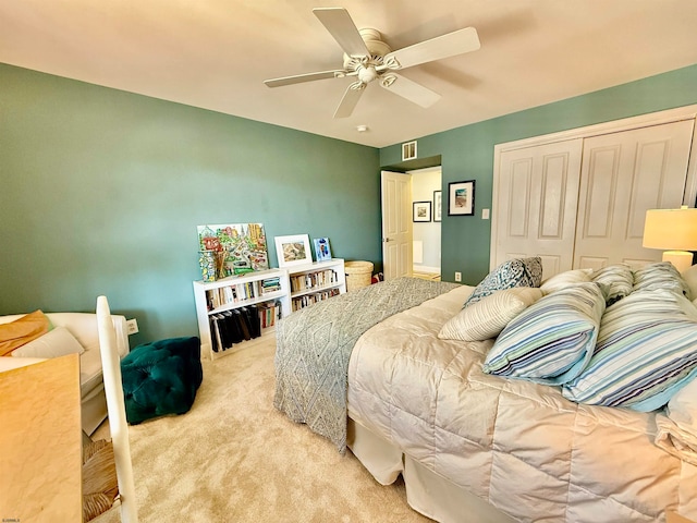 bedroom featuring a closet, ceiling fan, and light colored carpet