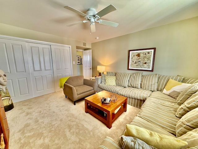 carpeted living room featuring ceiling fan