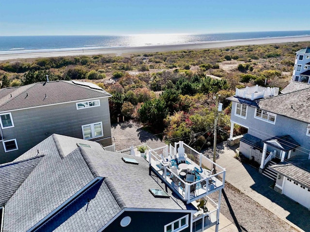 birds eye view of property featuring a view of the beach and a water view