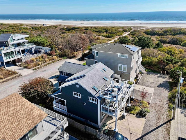 drone / aerial view with a water view and a view of the beach