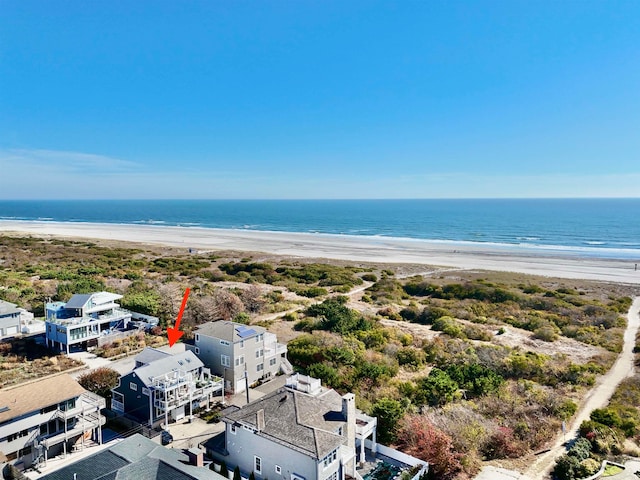 drone / aerial view featuring a water view and a beach view