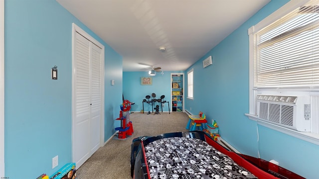 carpeted bedroom featuring a closet and multiple windows