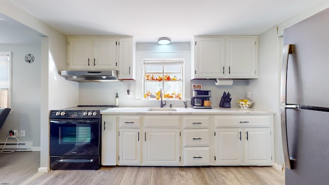 kitchen with sink, light hardwood / wood-style flooring, electric range, and stainless steel fridge