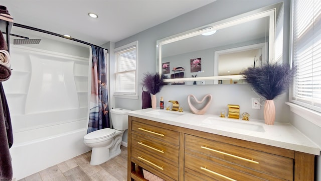 full bathroom with toilet, hardwood / wood-style floors, shower / bath combo with shower curtain, and vanity