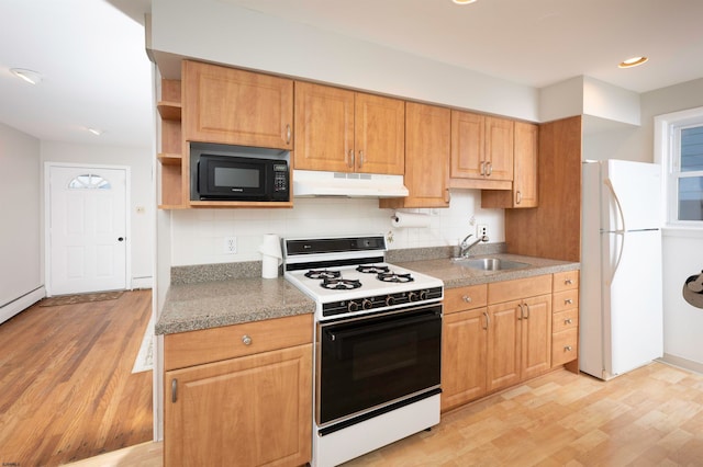 kitchen featuring sink, light hardwood / wood-style flooring, decorative backsplash, and white appliances