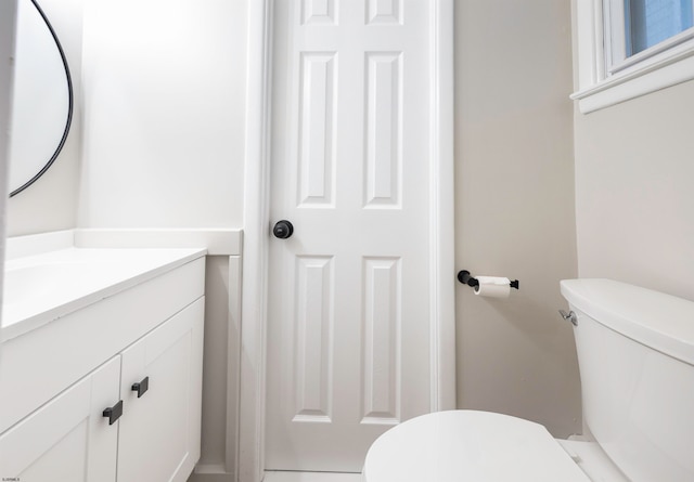 bathroom with toilet and vanity