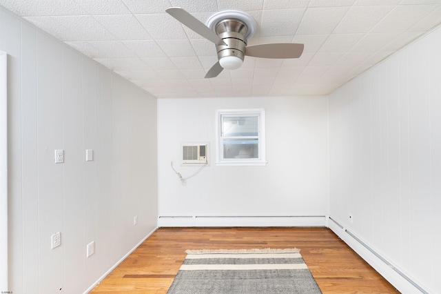 unfurnished room featuring wood-type flooring, a baseboard radiator, and ceiling fan