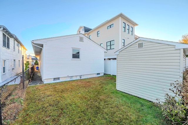 rear view of property featuring a lawn