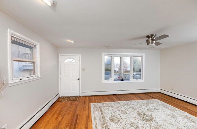 entryway featuring ceiling fan, wood-type flooring, and a baseboard radiator