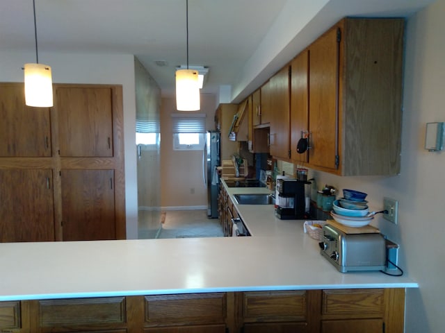 kitchen with kitchen peninsula, range, and pendant lighting