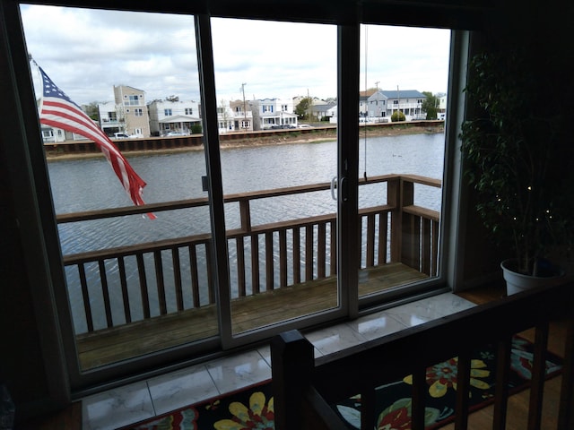 dock area featuring a water view and a balcony