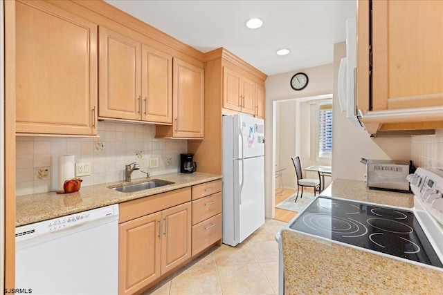 kitchen featuring white appliances, light brown cabinetry, sink, decorative backsplash, and light tile patterned floors