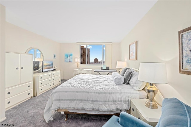 bedroom with multiple windows, lofted ceiling, and carpet