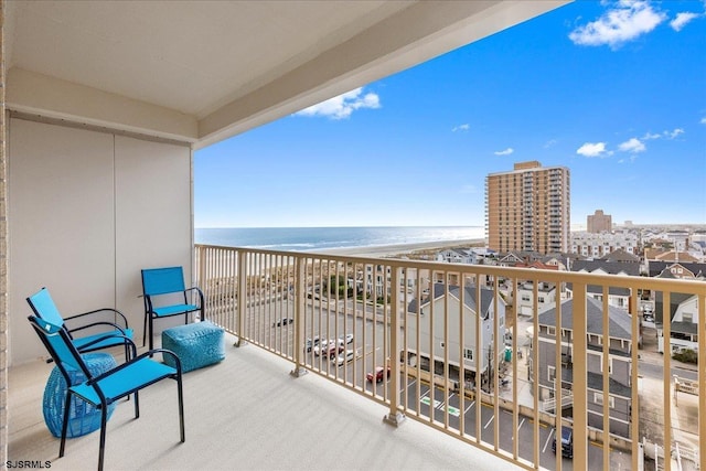 balcony featuring a water view and a beach view