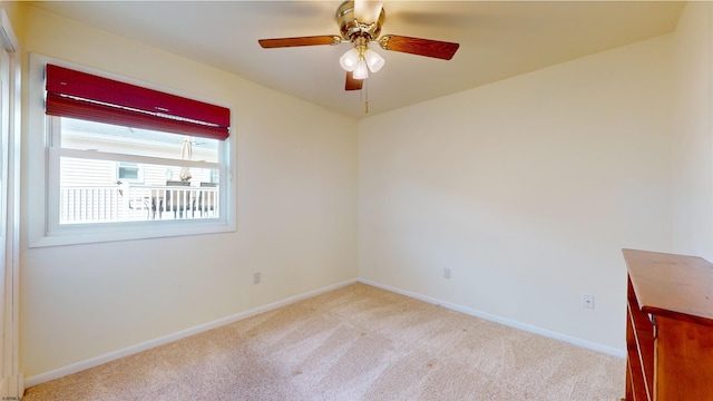 empty room featuring light carpet and ceiling fan