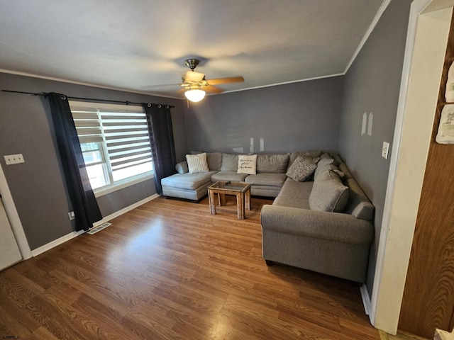 living room featuring ceiling fan, crown molding, and wood-type flooring