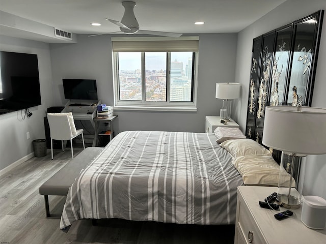 bedroom with hardwood / wood-style floors and ceiling fan