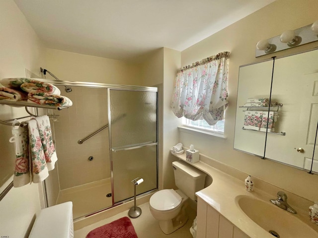 bathroom featuring vanity, a shower with shower door, toilet, and tile patterned flooring