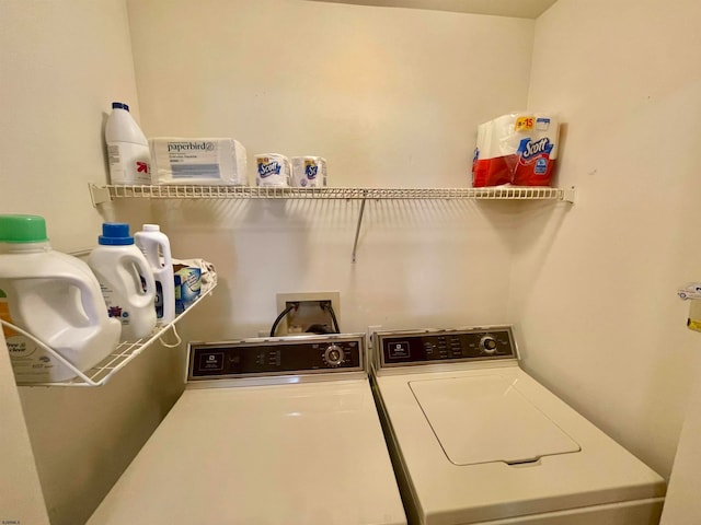 clothes washing area with washer and clothes dryer