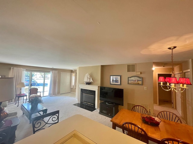 living room featuring carpet floors and an inviting chandelier