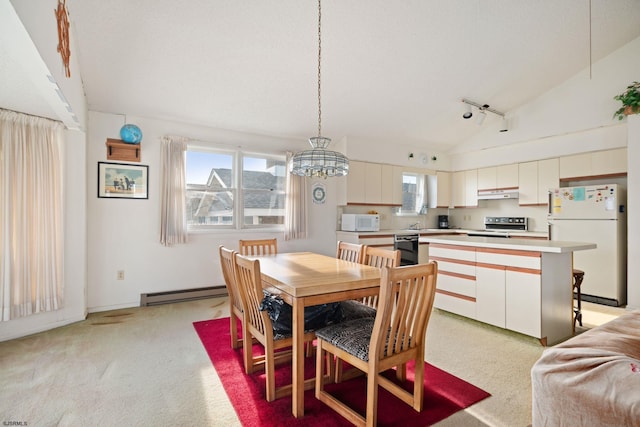 carpeted dining room featuring a baseboard radiator, rail lighting, an inviting chandelier, vaulted ceiling, and sink