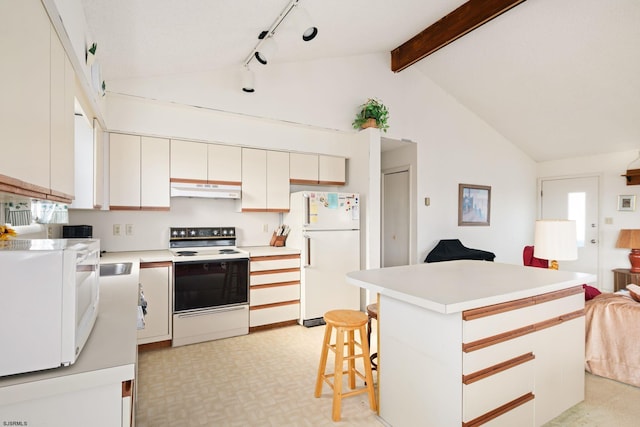 kitchen with white appliances, a center island, white cabinetry, beamed ceiling, and a breakfast bar area