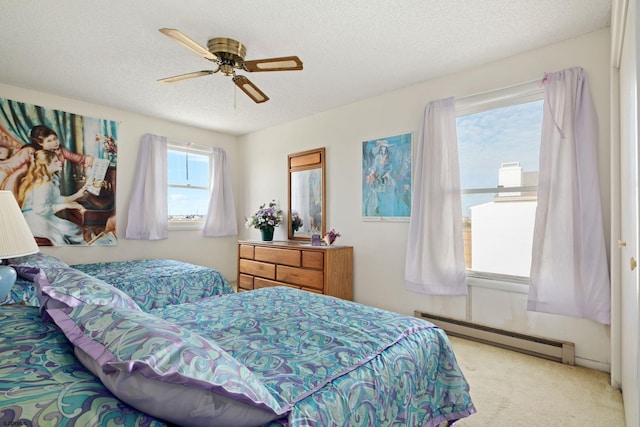 carpeted bedroom with a textured ceiling, a baseboard radiator, and ceiling fan