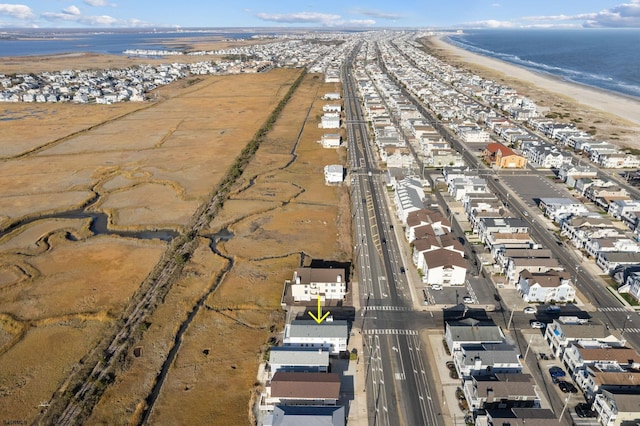 aerial view with a water view and a beach view