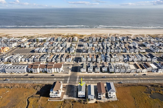 bird's eye view with a water view and a view of the beach