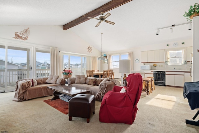 carpeted living room featuring beam ceiling, ceiling fan, a textured ceiling, high vaulted ceiling, and sink