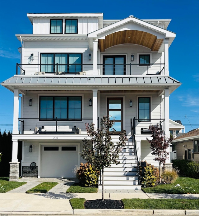 view of front of property featuring a balcony and a garage