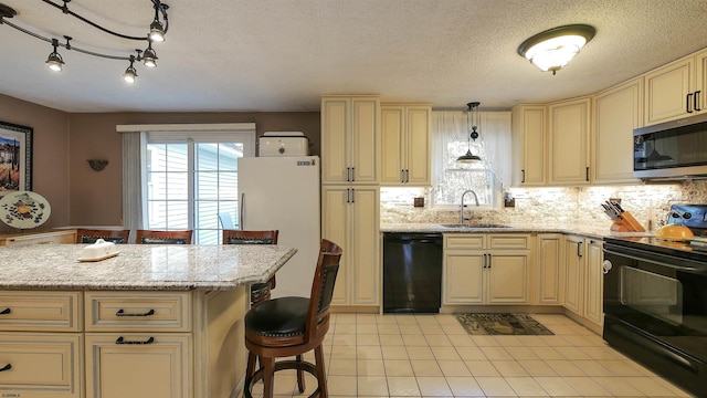 kitchen with a kitchen breakfast bar, sink, black appliances, decorative light fixtures, and a textured ceiling