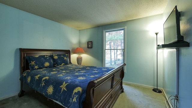 bedroom featuring light carpet and a textured ceiling