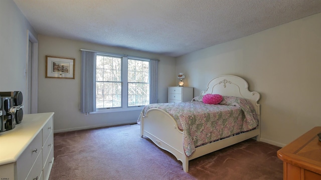 bedroom featuring a textured ceiling and dark carpet