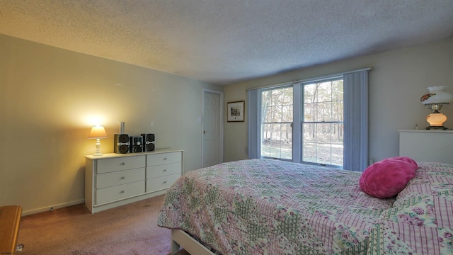 bedroom with a textured ceiling and carpet floors