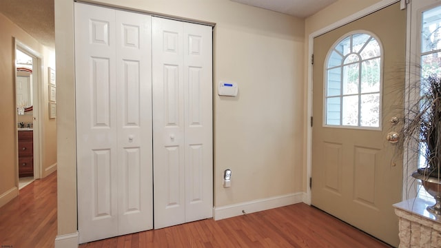 entryway featuring hardwood / wood-style floors and a textured ceiling